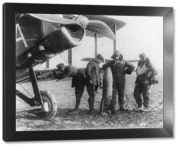 Aircrew of 27 Squadron examine a 230lb bomb
