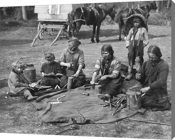 Romany children making clothes pegs