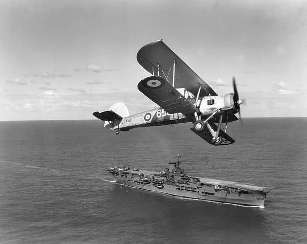 Fairey Swordfish I of 820 Squadron over HMS Ark Royal, 1939