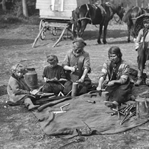 Romany children making clothes pegs