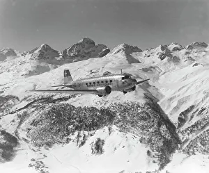 : A DC-2 of Swissair, flying near St Moritz, Switzerland, 1938